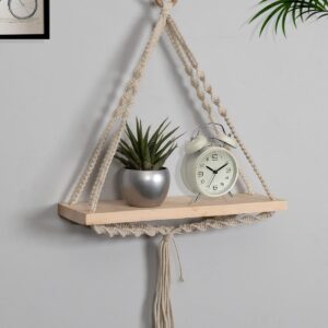 Front view of beige macrame wall hanging shelf with wood plank
