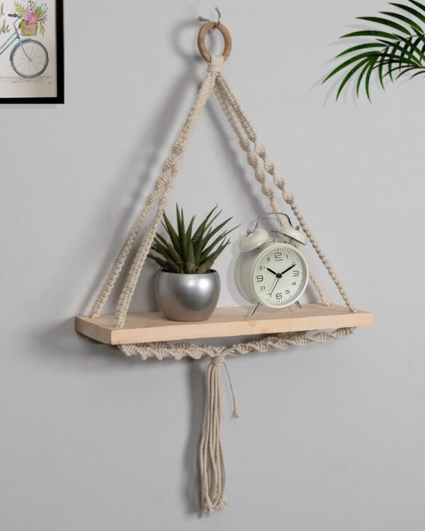 Front view of beige macrame wall hanging shelf with wood plank