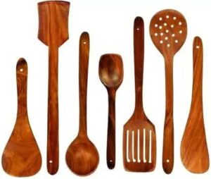 Handcrafted 7-piece teak wood kitchen utensil set for cooking and serving.